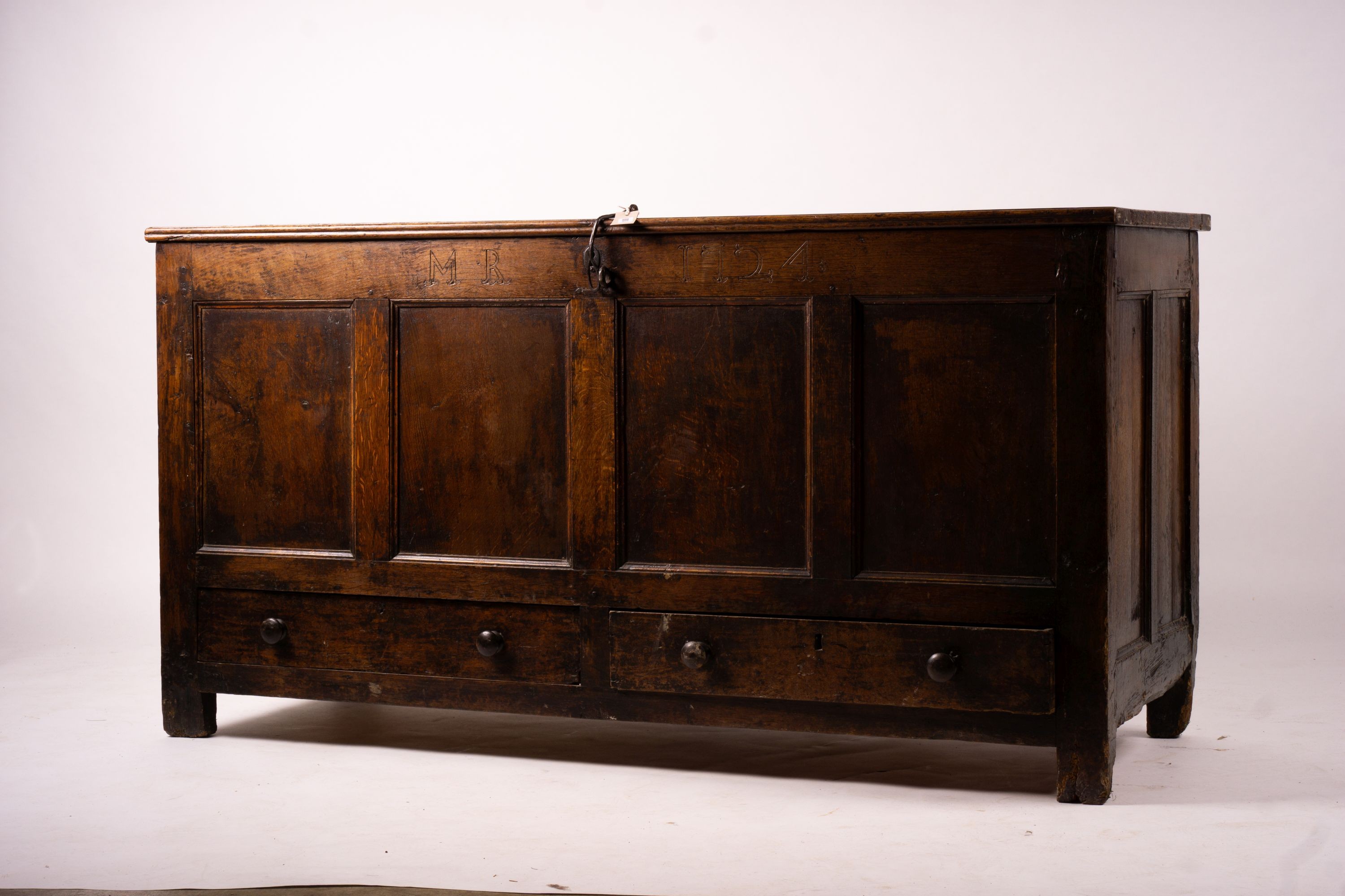 An 18th century panelled oak mule chest, length 161cm, depth 61cm, height 84cm